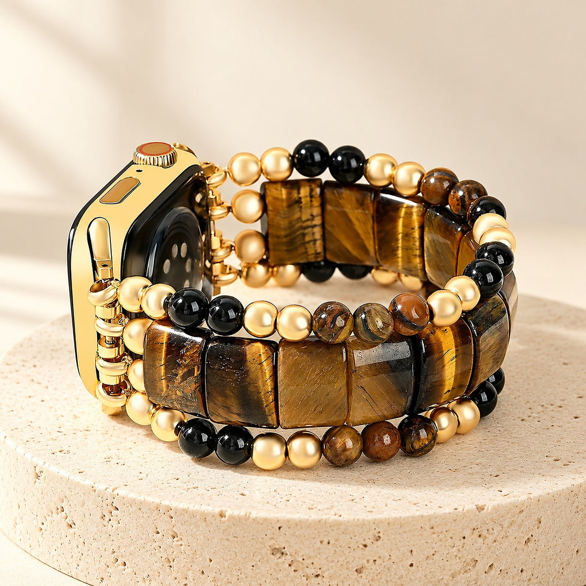 Fearless Heart tiger's eye stretch Apple Watch strap on a gold Apple Watch, standing on a travertine pedestal